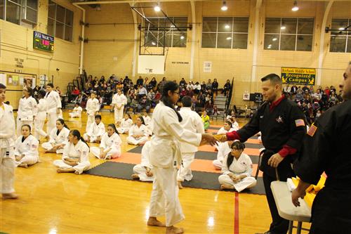 Karate student receives her belt 